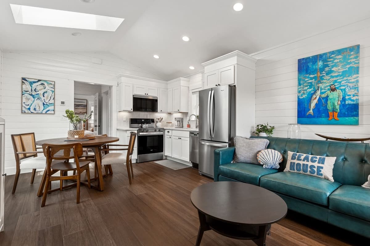 Open living and dining area with vaulted shiplap ceiling